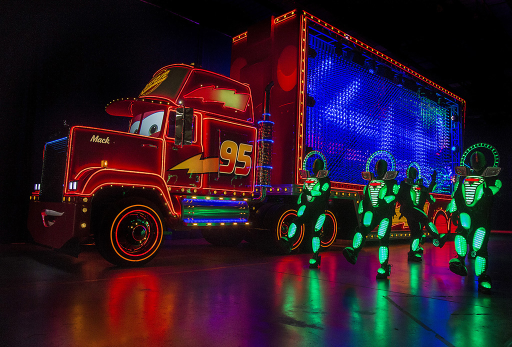 MACK AND THE CARS CREW PREVIEW "PAINT THE NIGHT" (April 14, 2015) — Mack from the Disney●Pixar 'Cars' films, one of the characters featured in the all-new after-dark spectacular, "Paint the Night," appears with parade performers in synchronized, LED costumes during a backstage media preview at Disneyland park. Inspired by the "Main Street Electrical Parade," "Paint the Night" is full of vibrant color and more than 1.5 million, brilliant LED lights and features special effects, unforgettable music, and energetic performances that bring beloved Disney and Disney●Pixar stories to life. Celebrating 60 years of magic, "Paint the Night" is one of three new nighttime spectaculars which will immerse guests in the worlds of Disney stories like never before. The Diamond Celebration at the Disneyland Resort begins Friday, May 22, 2015. (Paul Hiffmeyer/Disneyland Resort)
