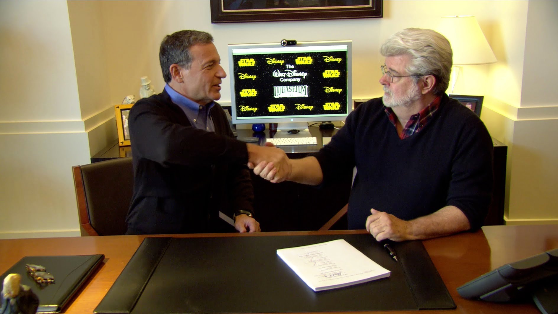 George Lucas and Bob Iger sign Lucasfilm and Star Wars over to The Walt Disney Company in 2013. 